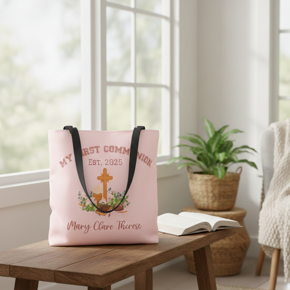 Pink tote bag with religious design on a wooden table in a bright room.