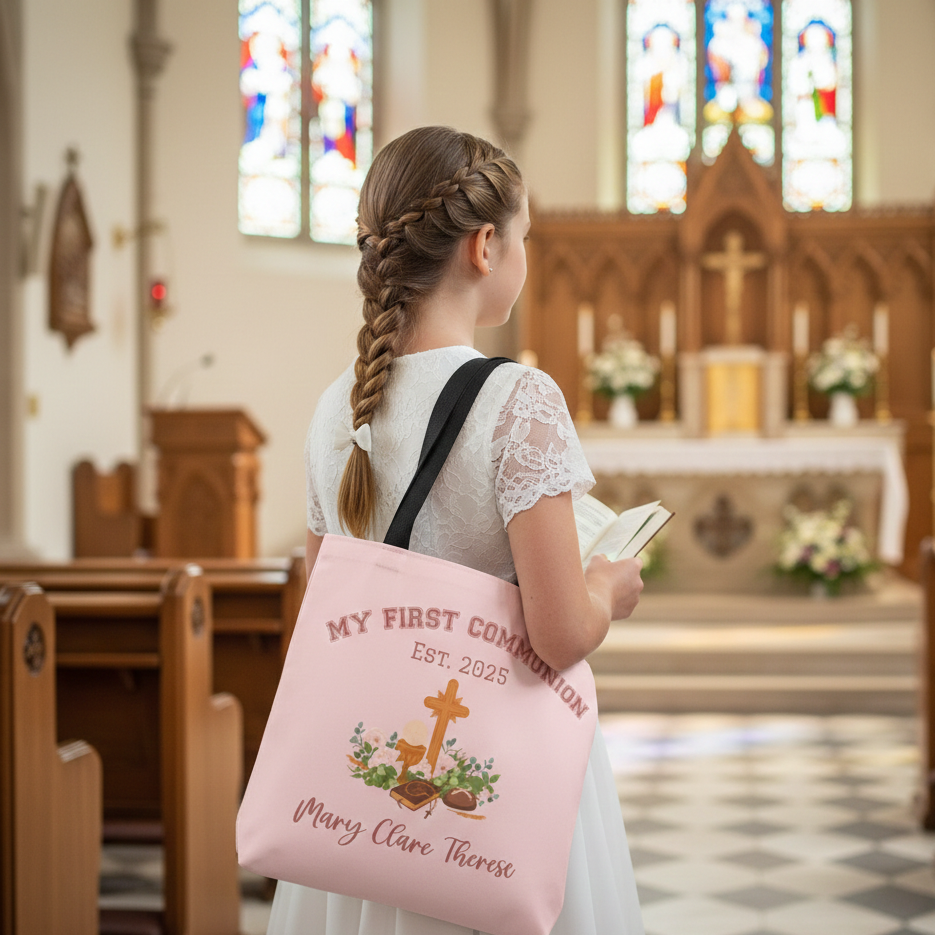 Girl holding a pink tote bag with 'My First Communion' text in a church setting