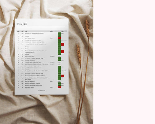 May include: A white printed calendar for July 2026, with a list of dates and events. The calendar is on a beige fabric surface, with two stalks of wheat. The calendar has green and red color-coded columns.